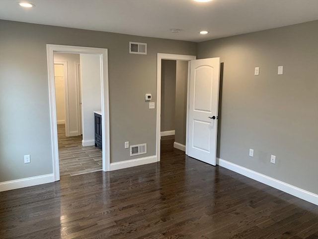 unfurnished bedroom with dark hardwood / wood-style floors