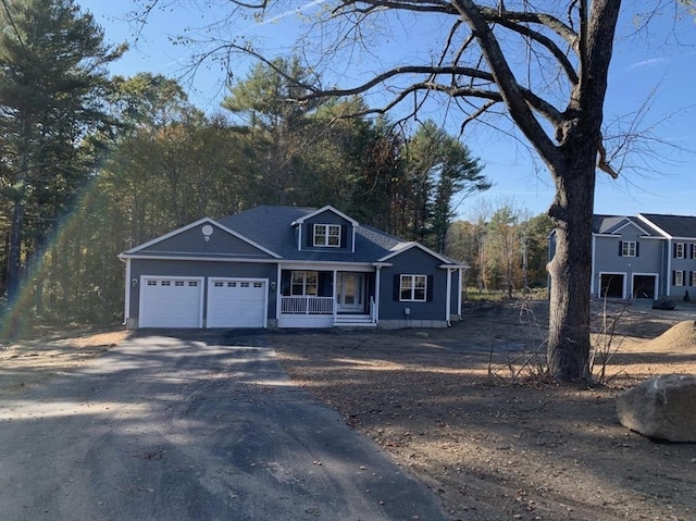 view of front of property featuring a garage and covered porch