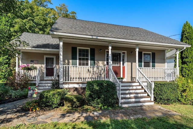 bungalow-style home featuring a porch and a shingled roof