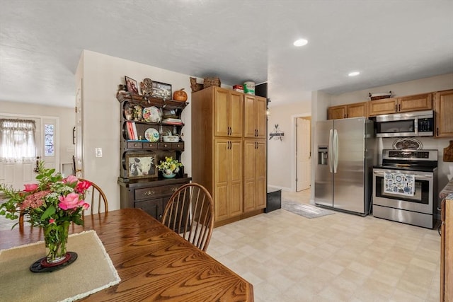 kitchen featuring recessed lighting, light floors, and appliances with stainless steel finishes