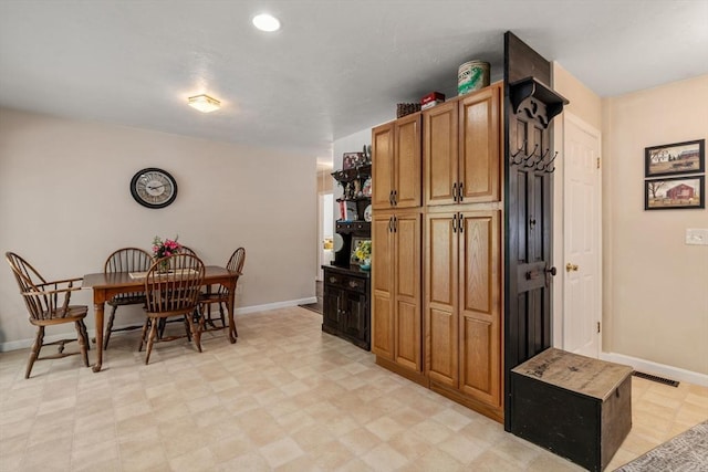 kitchen featuring visible vents, brown cabinets, recessed lighting, baseboards, and light floors