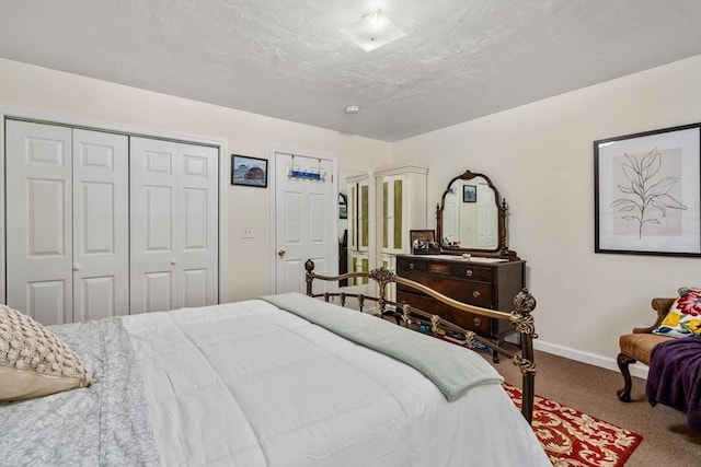 bedroom with carpet, baseboards, a closet, and a textured ceiling