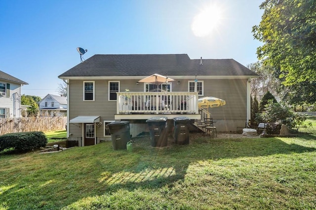 rear view of property with a lawn and a wooden deck