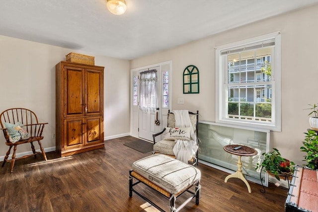 sitting room with dark wood-style floors and baseboards