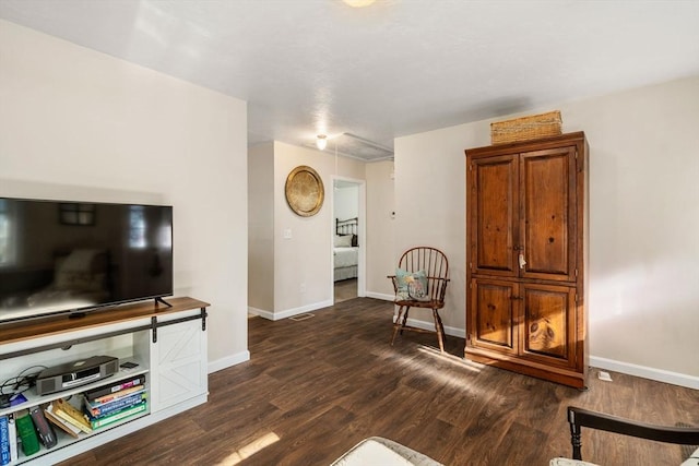 living area featuring dark wood-style floors, visible vents, and baseboards