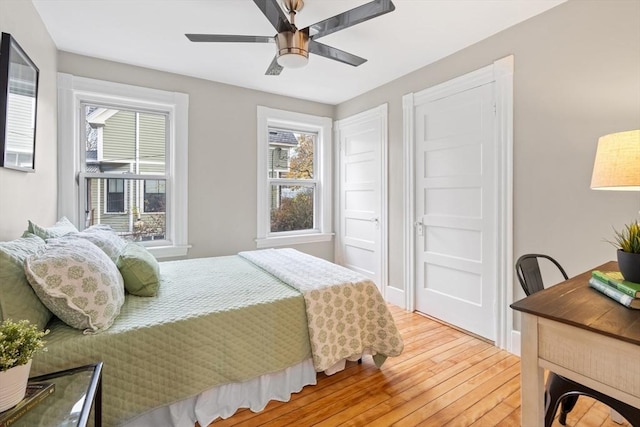 bedroom with ceiling fan and wood-type flooring