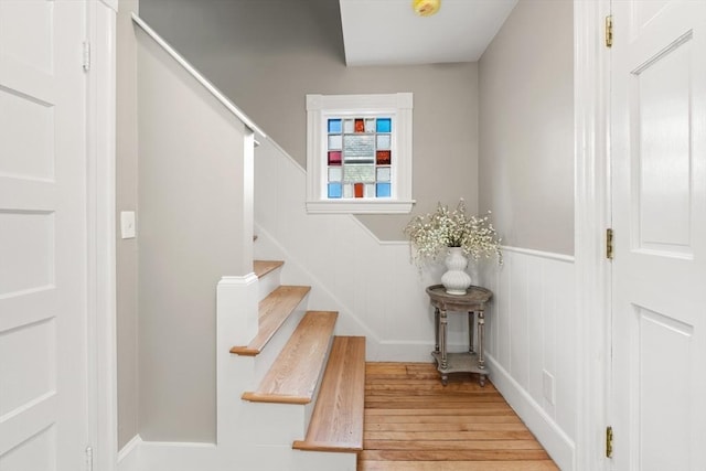 stairs featuring hardwood / wood-style floors