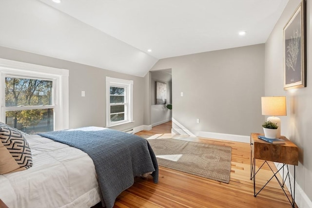 bedroom with lofted ceiling and light wood-type flooring