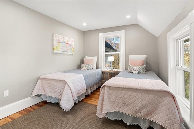 bedroom with hardwood / wood-style floors and vaulted ceiling