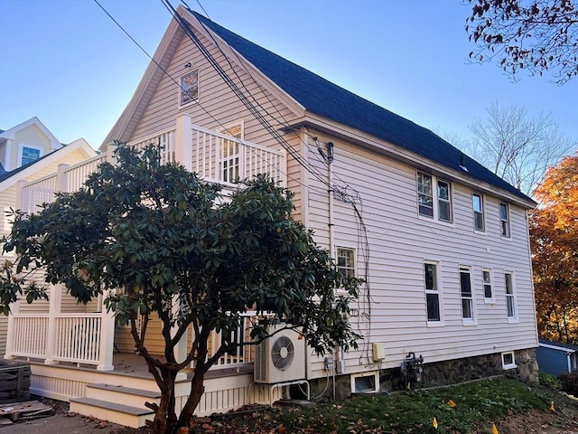 view of side of home with ac unit