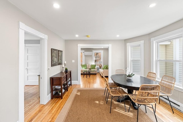 dining room featuring light wood-type flooring and baseboard heating