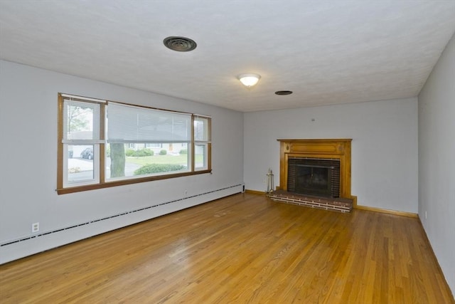13 Louise Ave, Chicopee, MA 01013 - unfurnished living room featuring a baseboard heating unit, wood finished floors, and a fireplace