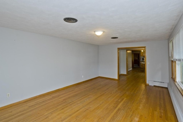 13 Louise Ave, Chicopee, MA 01013 - empty room with light wood-style flooring and baseboard heating