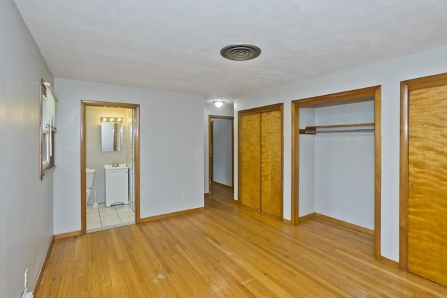13 Louise Ave, Chicopee, MA 01013 - unfurnished bedroom featuring multiple closets, light wood-style flooring, and ensuite bathroom