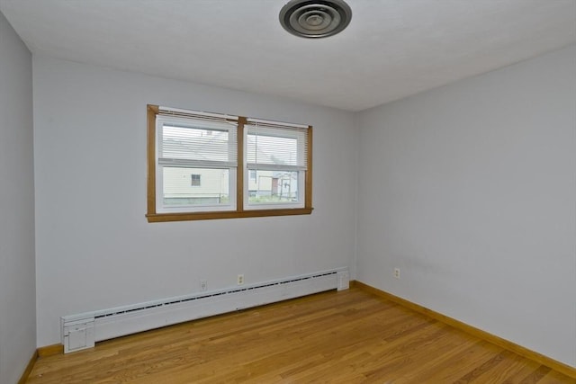 13 Louise Ave, Chicopee, MA 01013 - empty room with a baseboard radiator and light wood-style floors