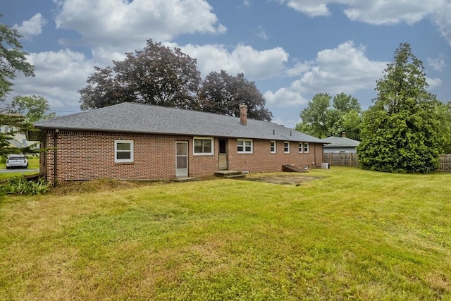 13 Louise Ave, Chicopee, MA 01013 - back of house featuring brick siding, a chimney, and roof with shingles