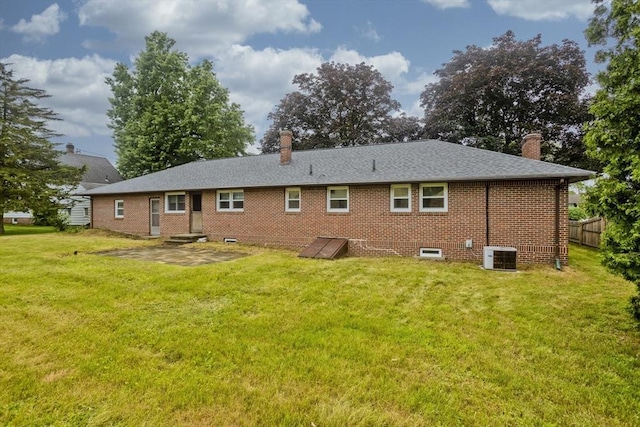 13 Louise Ave, Chicopee, MA 01013 - rear view of house featuring a chimney, brick siding, and a patio