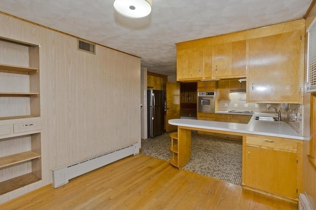 13 Louise Ave, Chicopee, MA 01013 - kitchen with freestanding refrigerator, oven, baseboard heating, light countertops, and light wood-type flooring