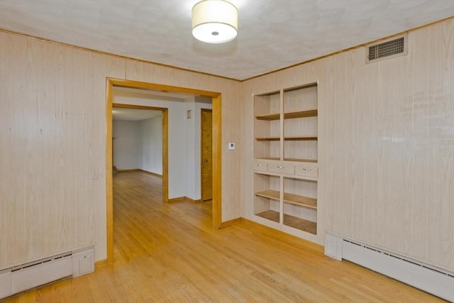 13 Louise Ave, Chicopee, MA 01013 - spare room with a baseboard radiator, wood finished floors, built in shelves, wood walls, and ornamental molding