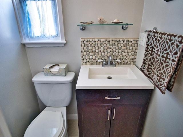 bathroom with vanity, tasteful backsplash, and toilet