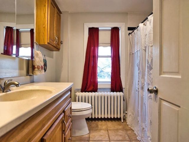 bathroom featuring tile patterned floors, radiator, vanity, and toilet