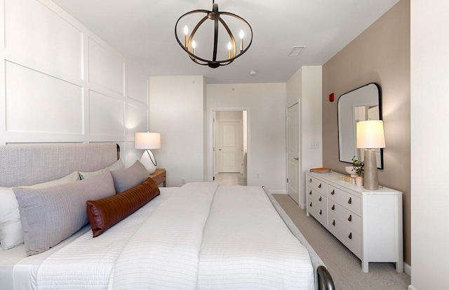 carpeted bedroom featuring a notable chandelier