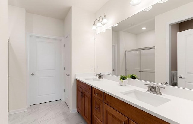 bathroom with vanity and a shower with door