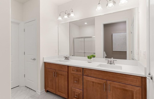 bathroom with vanity and a shower with shower door