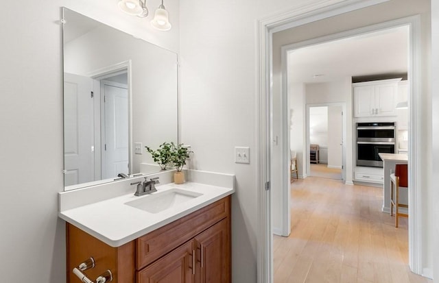 bathroom featuring hardwood / wood-style floors and vanity