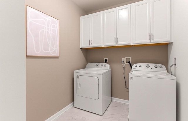 laundry area featuring washer and dryer and cabinets