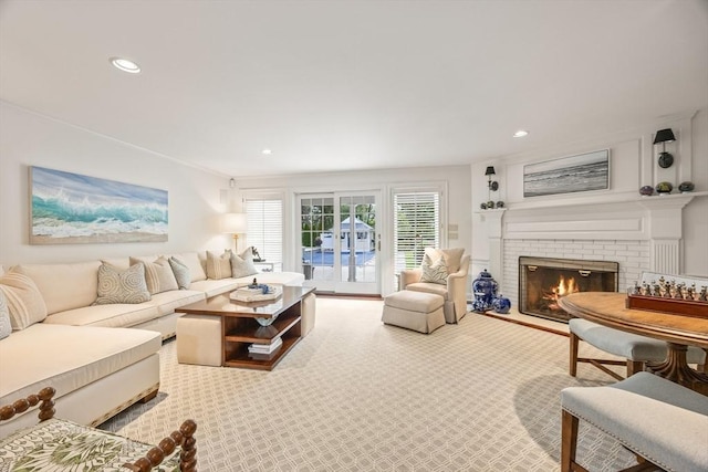 living room with a fireplace and carpet floors