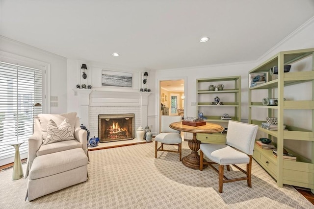 sitting room featuring ornamental molding and a brick fireplace