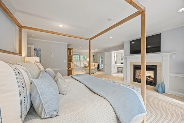 carpeted bedroom featuring ensuite bath and ornamental molding