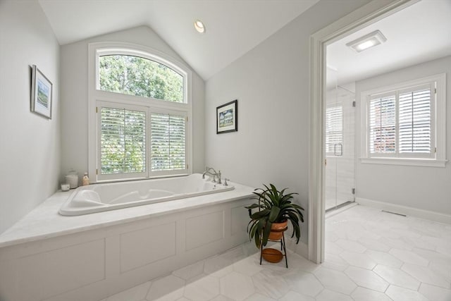 bathroom with tile patterned floors, plus walk in shower, and vaulted ceiling