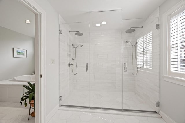 bathroom featuring shower with separate bathtub and a wealth of natural light