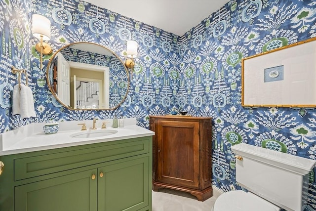 bathroom featuring tile patterned flooring, vanity, and toilet