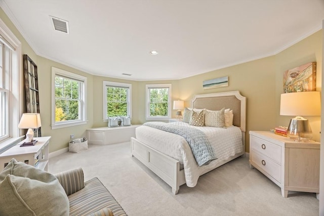 bedroom with light colored carpet and crown molding