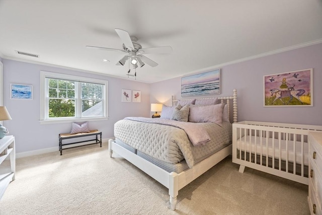 carpeted bedroom featuring ceiling fan and ornamental molding