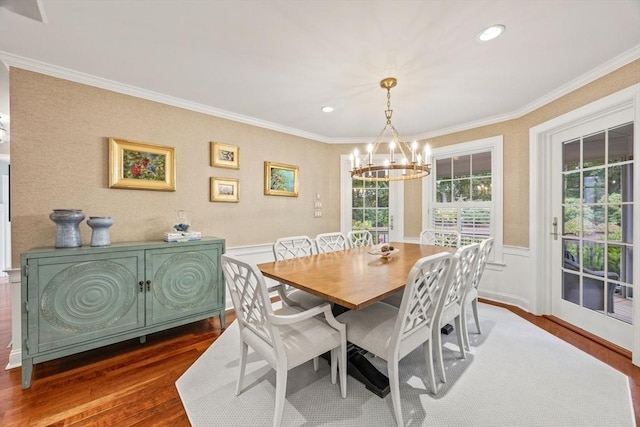 dining room with a chandelier, dark hardwood / wood-style flooring, and ornamental molding