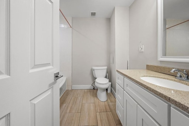 bathroom with toilet and vanity