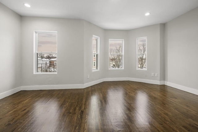 empty room featuring dark wood-type flooring