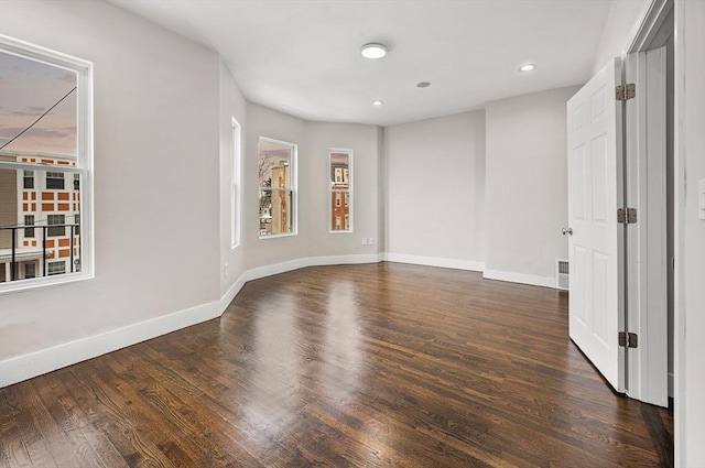 empty room with dark hardwood / wood-style floors