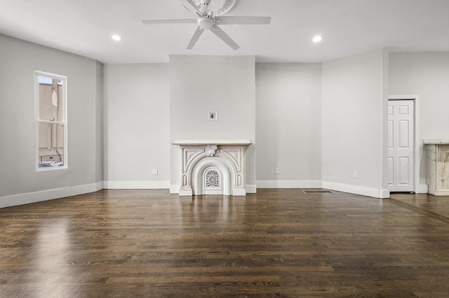 unfurnished living room with ceiling fan and dark hardwood / wood-style flooring