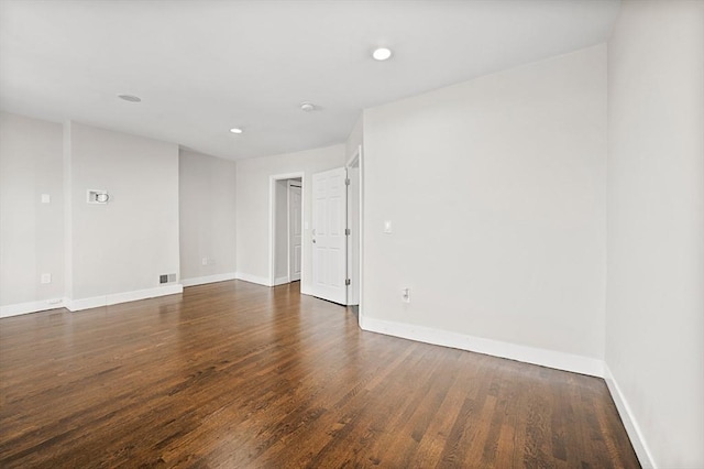 unfurnished room featuring dark wood-type flooring