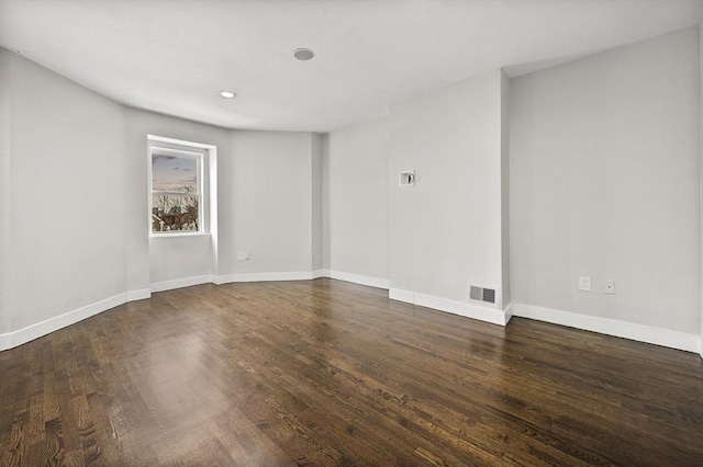 unfurnished room featuring dark hardwood / wood-style flooring