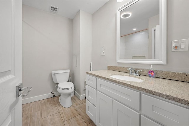 bathroom with toilet and vanity