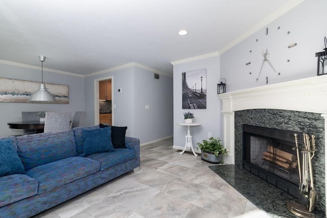 living room with crown molding, a premium fireplace, and baseboards
