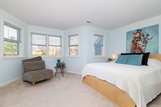 carpeted bedroom featuring crown molding, baseboards, and visible vents
