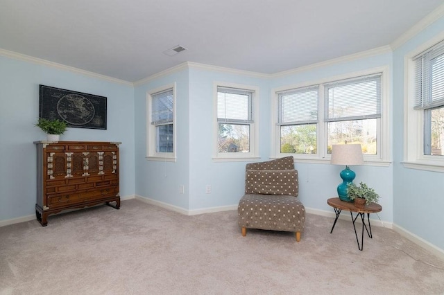 living area with crown molding, carpet, and baseboards