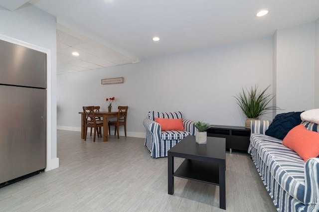 living area with recessed lighting, baseboards, and light wood-style floors